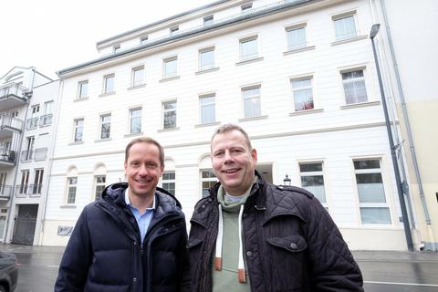 Eigentümer Florian Hirschmann (links) und Hans-Georg Böcher vor dem Alten Rathaus, dessen Steinquader-Optik nach historischem Vorbild mit aufwendiger Feinputz-Technik wiederhergestellt wurde. 