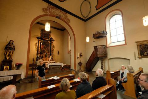 Melanie Hanold (stehend) weist auf die Details der Innenausstattung der Kirche hin. Martin Fromme
